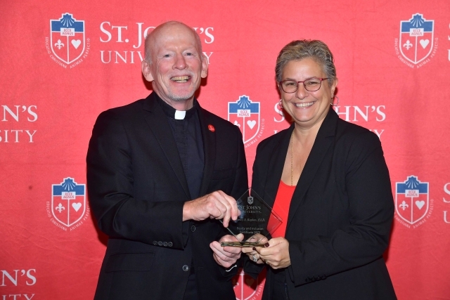 Fr. Shanley handing award to 2024 Training and Development Certificate Graduate