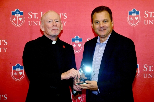 Fr. Shanley handing award to 2024 Training and Development Certificate Graduate
