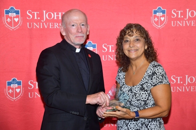 Fr. Shanley handing award to 2024 Training and Development Certificate Graduate