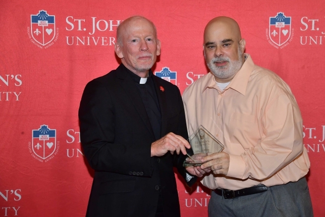 Fr. Shanley handing award to 2024 Training and Development Certificate Graduate