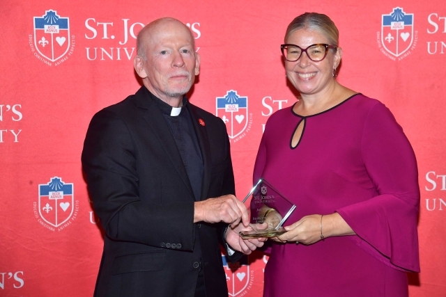 Fr. Shanley handing award to 2024 Training and Development Certificate Graduate
