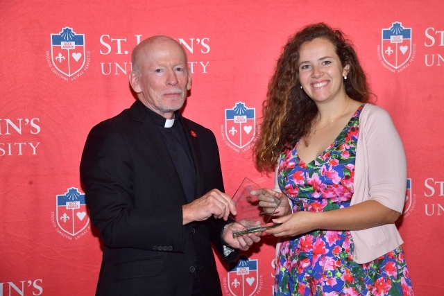 Fr. Shanley handing award to 2024 Training and Development Certificate Graduate