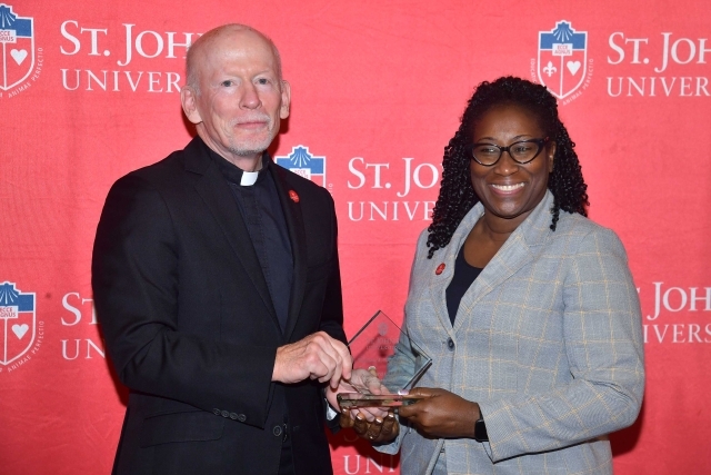 Fr. Shanley handing award to 2024 Training and Development Certificate Graduate