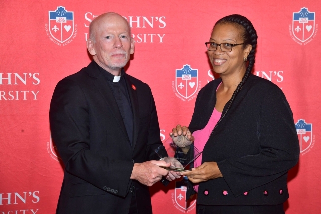 Fr. Shanley handing award to 2024 Training and Development Certificate Graduate