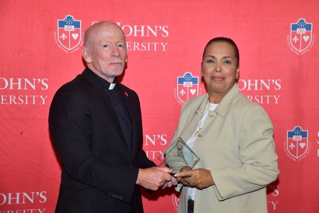 Fr. Shanley handing award to 2024 Training and Development Certificate Graduate
