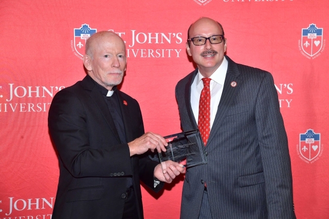 Fr. Shanley handing award to 2024 Training and Development Certificate Graduate