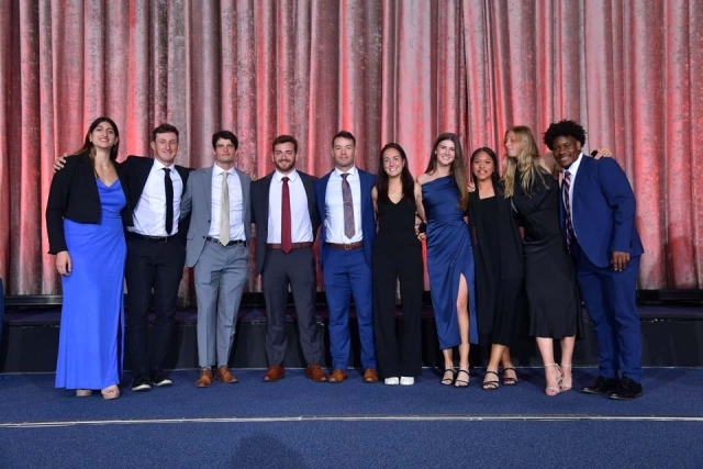 Group of students posing on stage at the St. John's University President's Dinner 