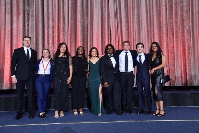 Group of students posing on stage at the St. John's University President's Dinner 