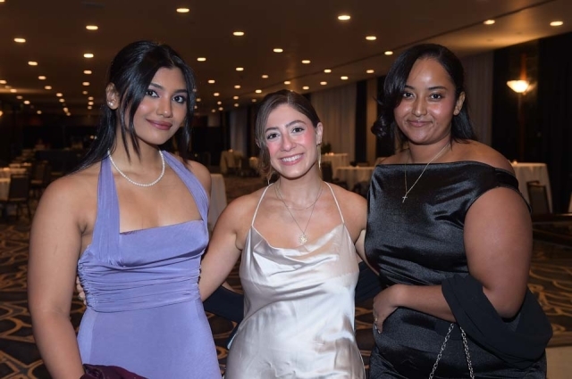 Three females dressed in gowns at St. John's President's Dinner