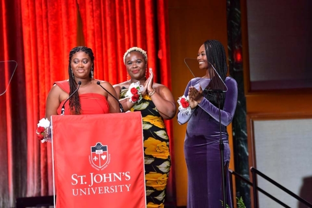 Three Females at podium speaking during the St. John's University President's Dinner