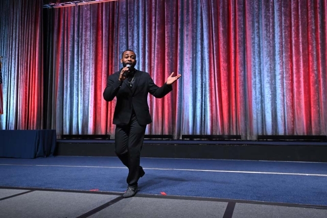 Male performing on stage during the St. John's President's Dinner 