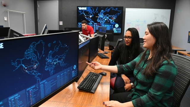 Three students working on computers in SJU Cyber Security Lab