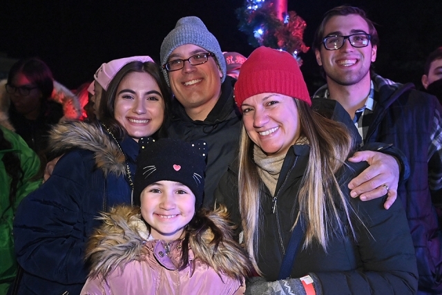 A group of students posing for a photo at the St. John's Christmas tree lighting 