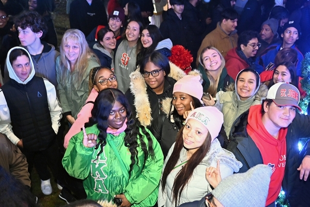 A group of students posing for a photo at the St. John's Christmas tree lighting 