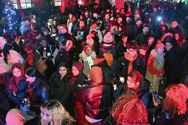 A group of students posing for a photo at the St. John's Christmas tree lighting 