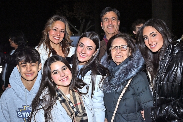 A group of students posing for a photo at the St. John's Christmas tree lighting 