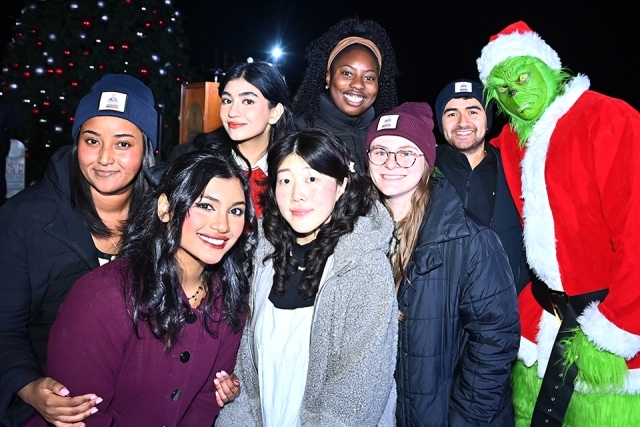 A group of students posing for a photo at the St. John's Christmas tree lighting 