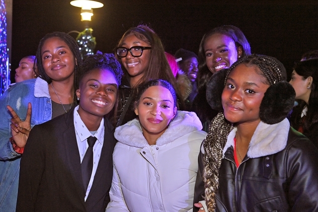 A group of students posing for a photo at the St. John's Christmas tree lighting 