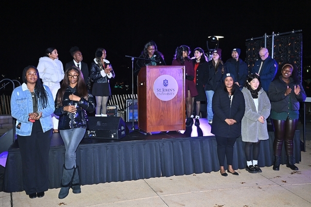 Students at the podium speaking at the St. John's Christmas tree lighting