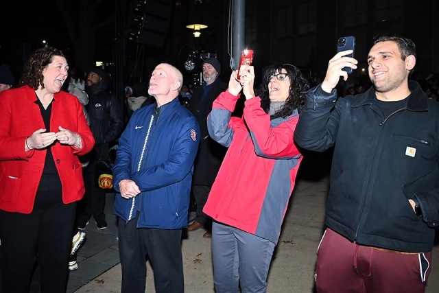 Fr Shanley and administrators watching the fireworks at the St. John's Christmas tree lighting