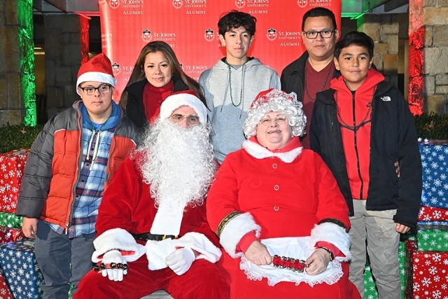 Santa and Ms Clause sitting with students at the Winter Carnival celebration