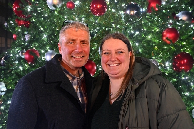 Three St. John's Alumni posing infront of Christmas tree