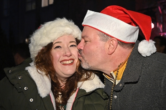 A male kissing the cheek of a female at the St. John's Winter Carnival celebration