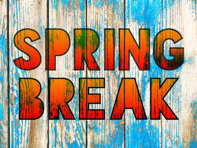 Graphic with the words Spring Break written on blue-tinged wood paneling.