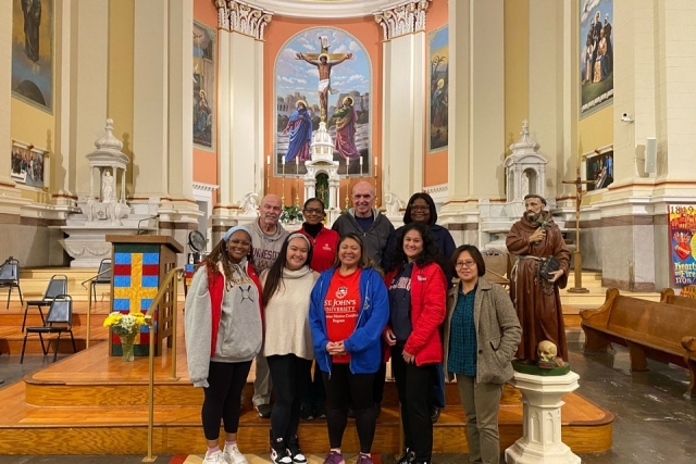 VMC cohort poses for a photo inside a church