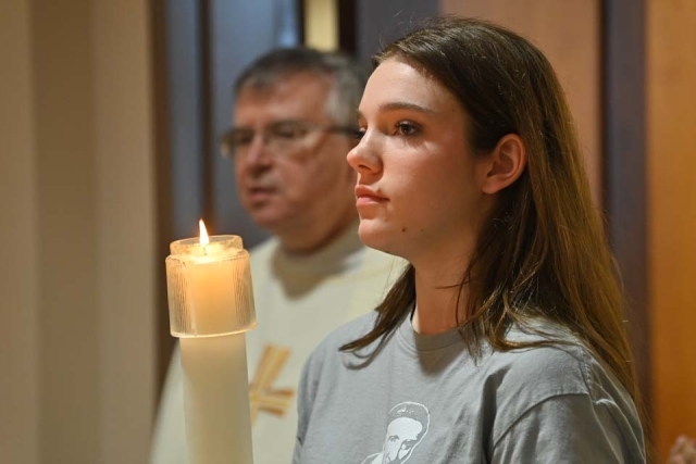 Woman holding candle in church