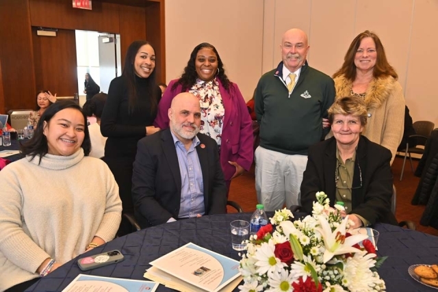 St. John's employees pose for a photo at a table