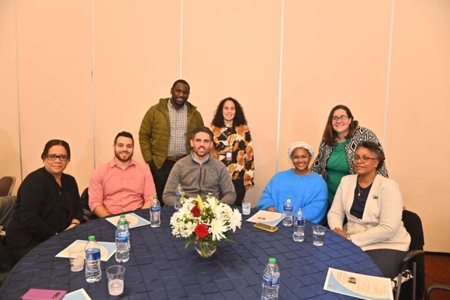 St. John's employees pose for a photo at a table