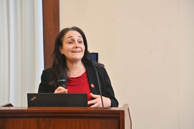 Lucy Pesce speaking at podium