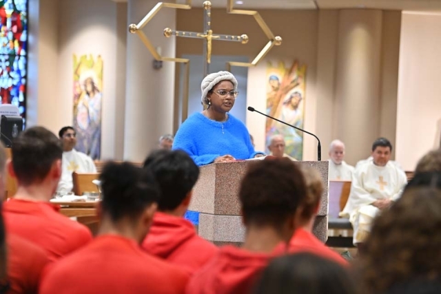 Cohort member speaking at podium