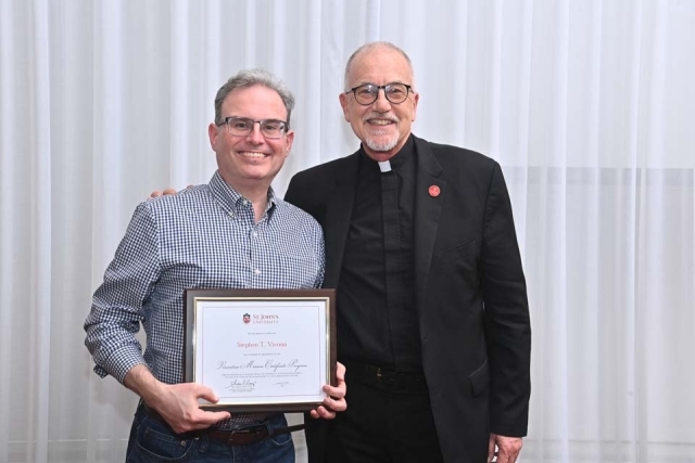Stephen Vivona and Fr. Rooney pose for a photo