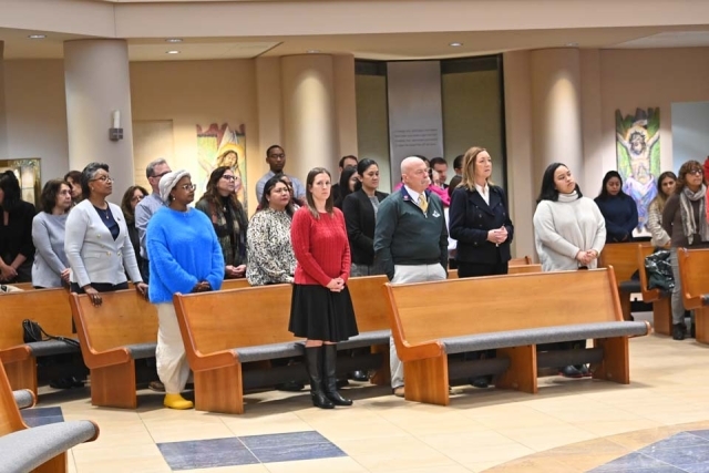 People standing at pews in church