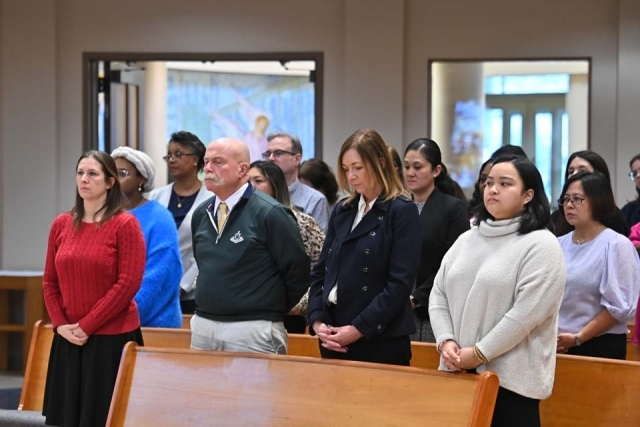 Group of people standing in the pews