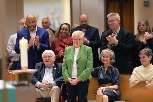 Couples applauding for a woman inside St. Thomas More Church