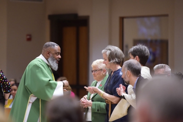 Priest blessing couples in church