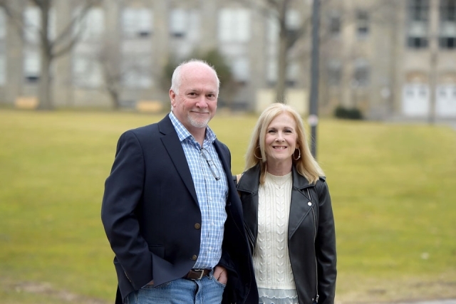 Couple poses for photo by Great Lawn
