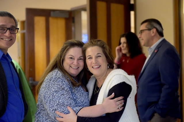 Two women pose for a photo