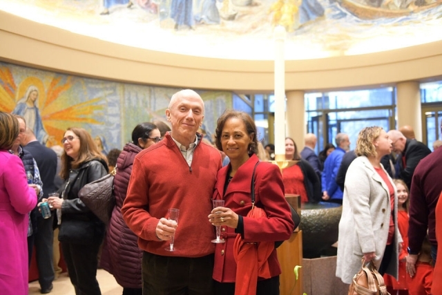 Couple posing for photo holding glasses of champagne