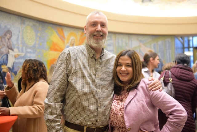 Couple posing for photo in church lobby