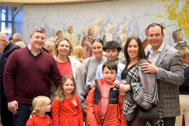Couples posing for photo with children