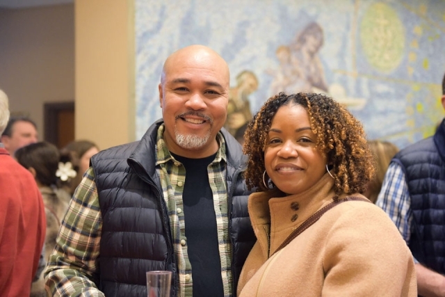 Couple posing for photo in church lobby