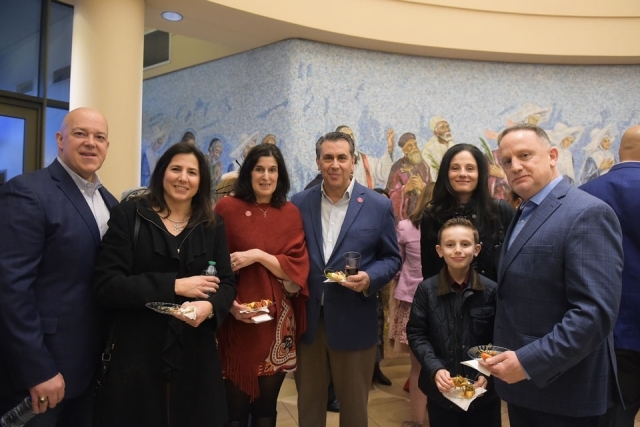 Couples pose for group photo in church