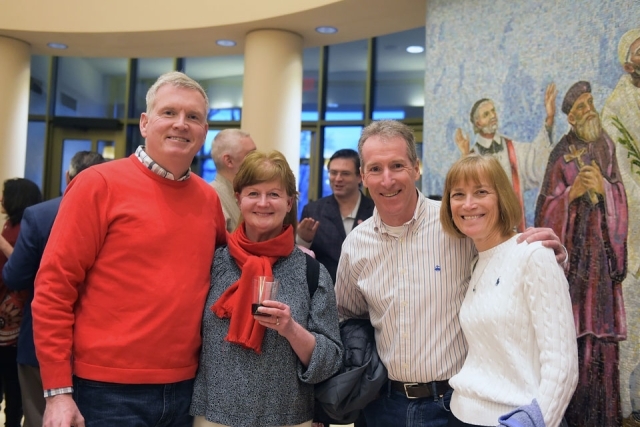 Couples pose for group photo in church