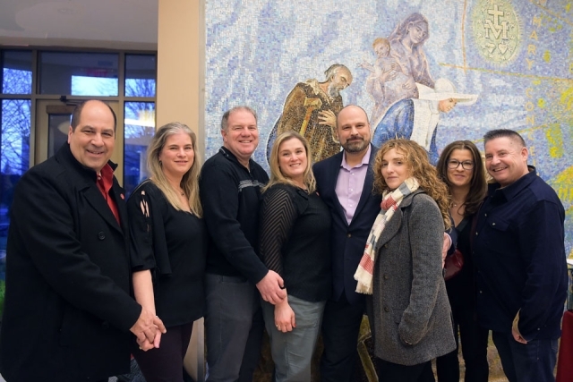 Couples pose for group photo in church