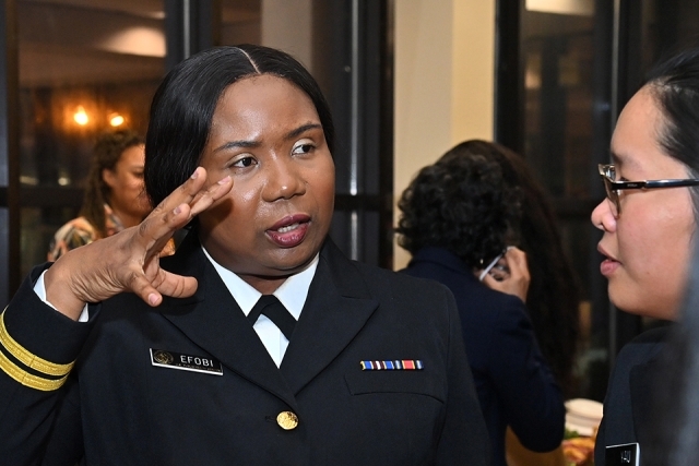 female military member in conversation with another woman
