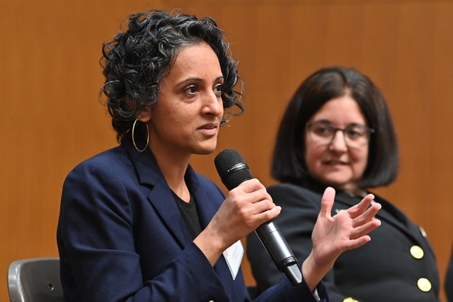 Female panelist speaking next to another woman